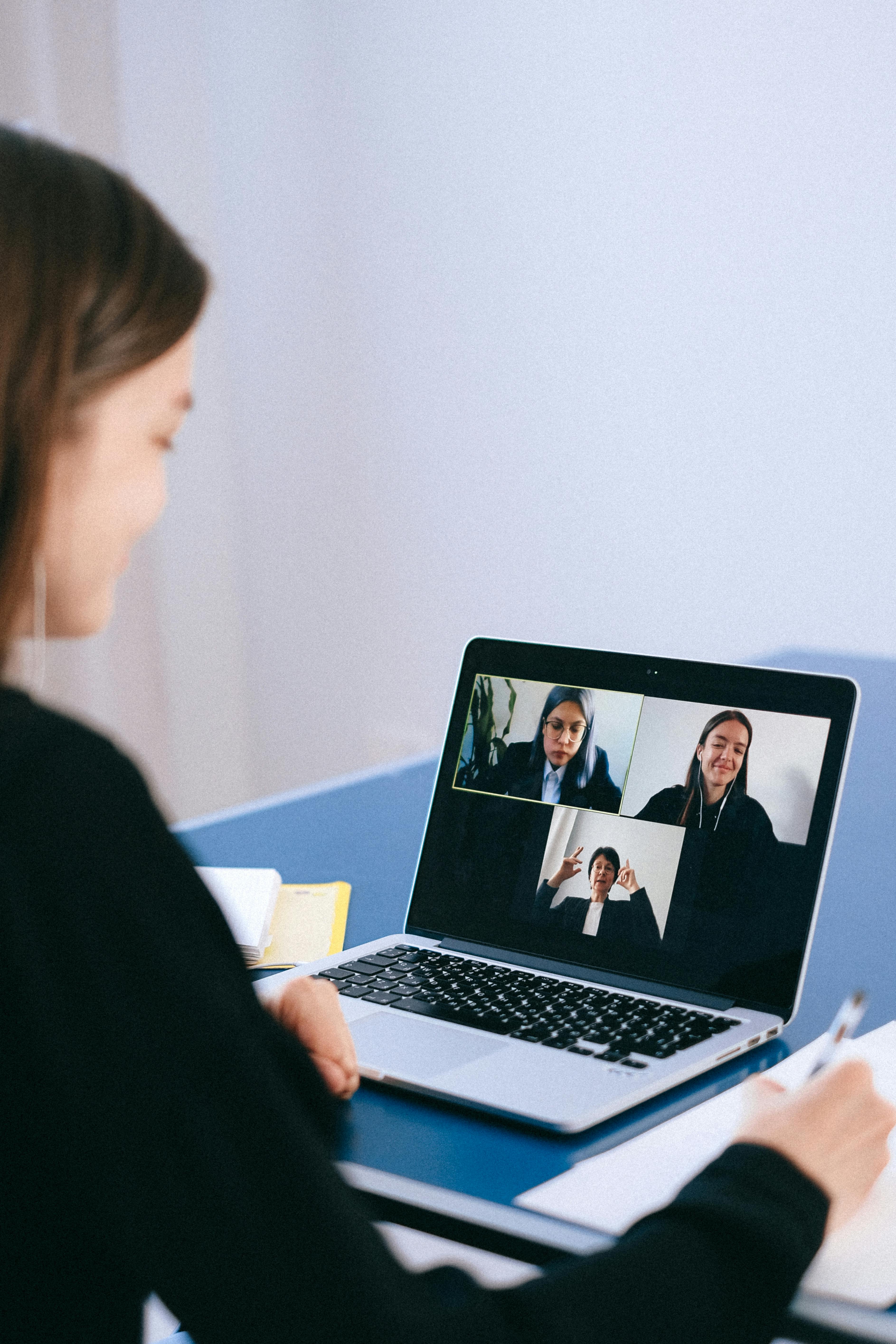 A virtual consultation — laptop screen showing a video call.